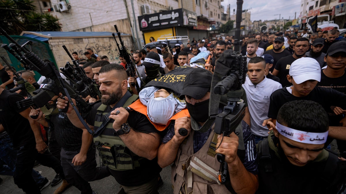 Mahmoud Al-Sous body being carried through crowd