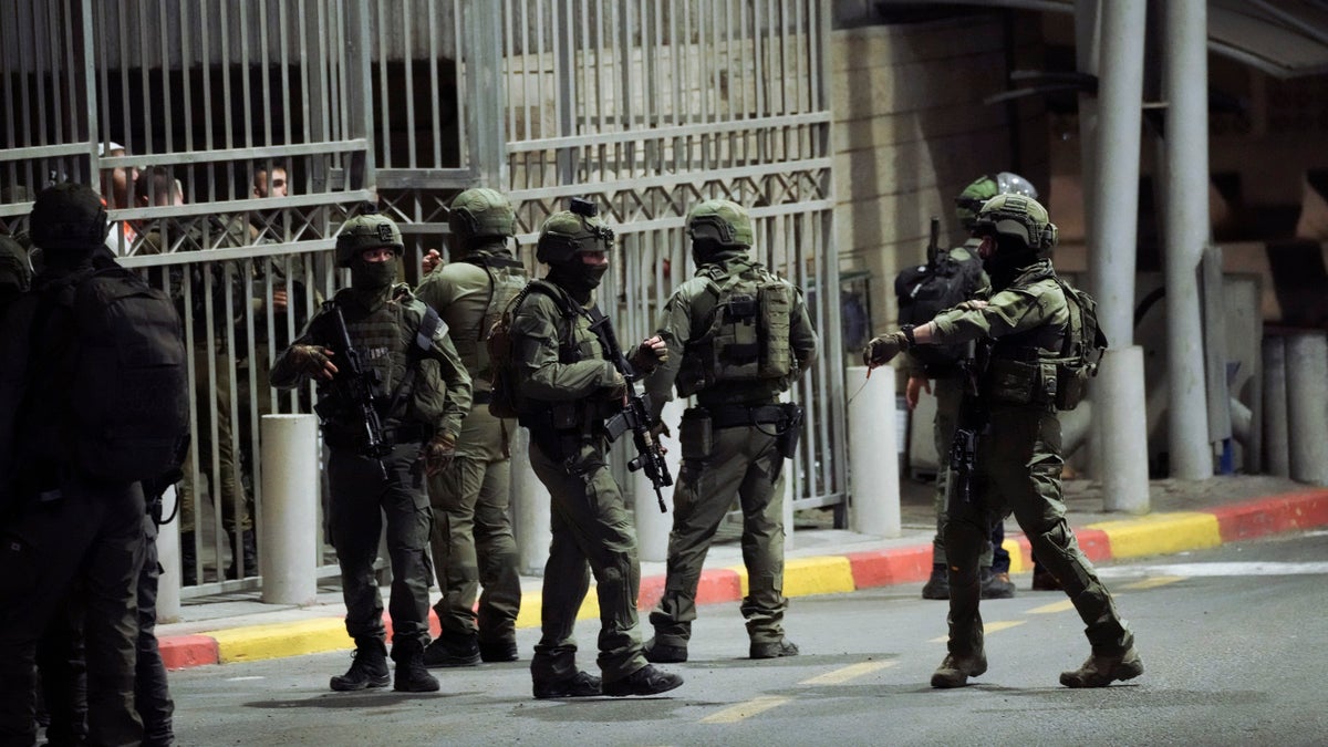 Israeli soldiers stand at a checkpoint