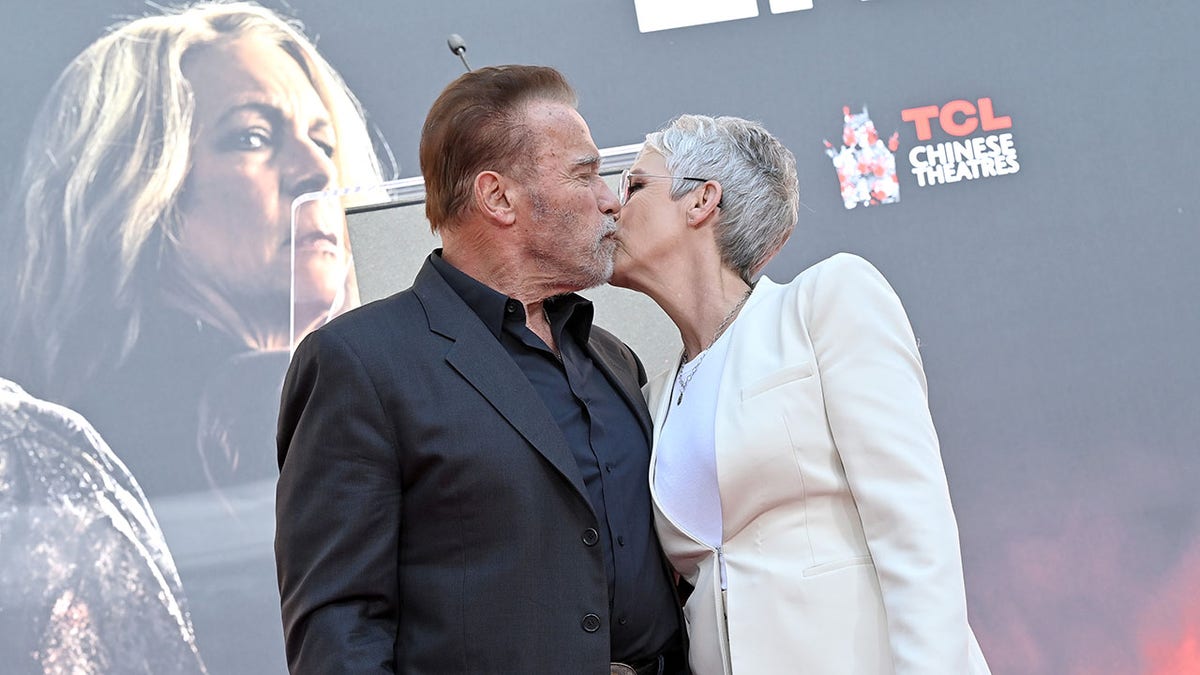 Arnold Schwarzenegger kisses Jamie Lee Curtis