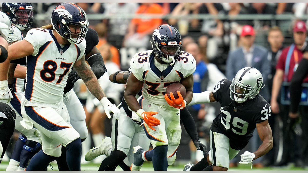 Javonte Williams runs