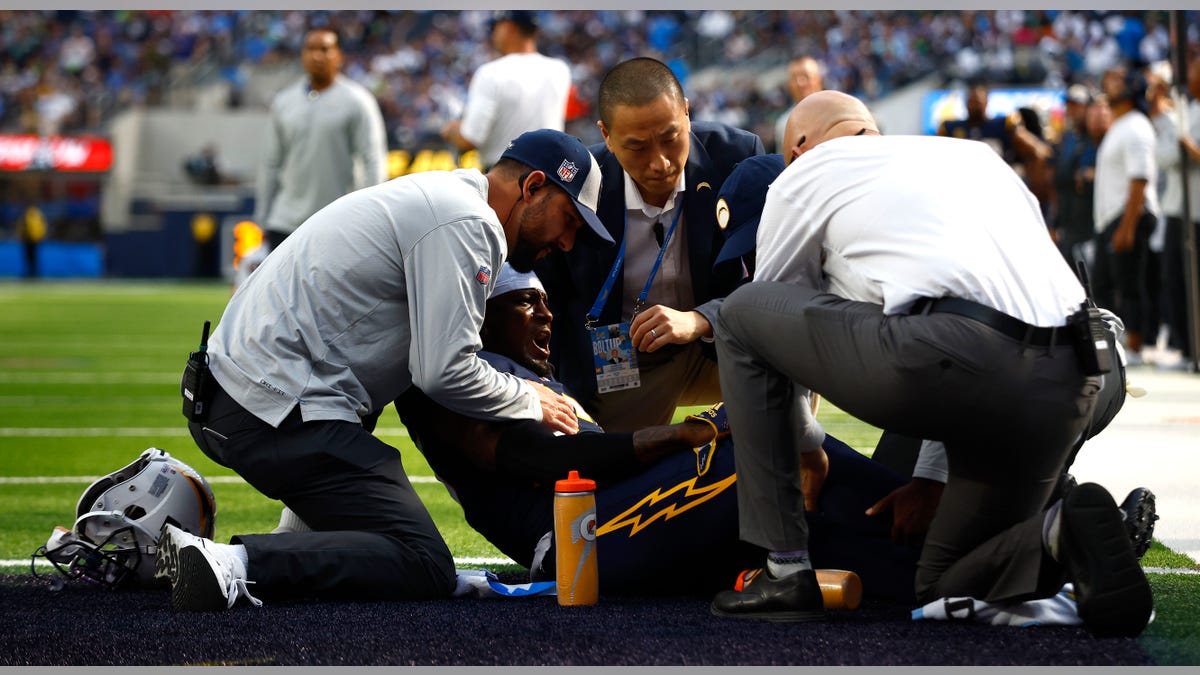 J.C. Jackson looked on by trainers