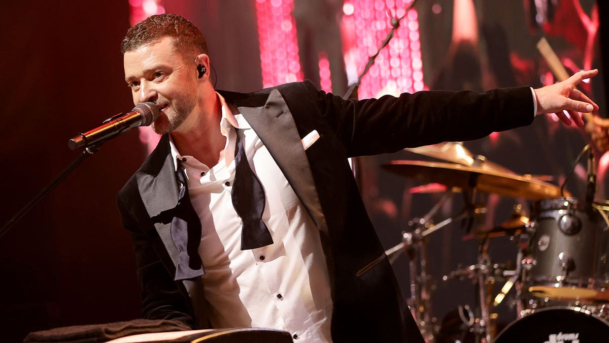 Justin Timberlake performing in a tuxedo on stage