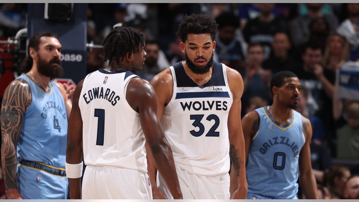 Anthony Edwards and Karl-Anthony Towns talk during a game