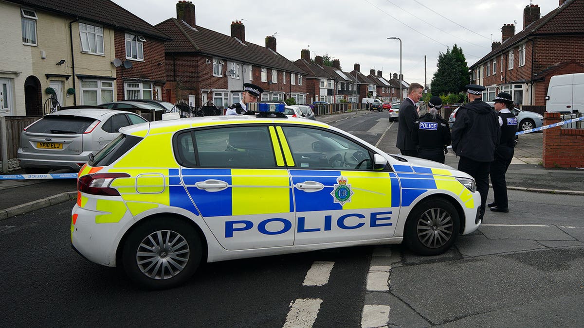 Liverpool patrol car with officers standing next to it