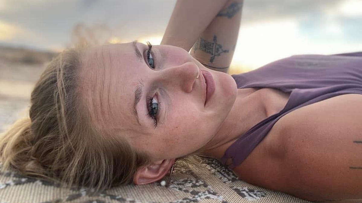 Maris DiGiovanni posing for photo in the sand