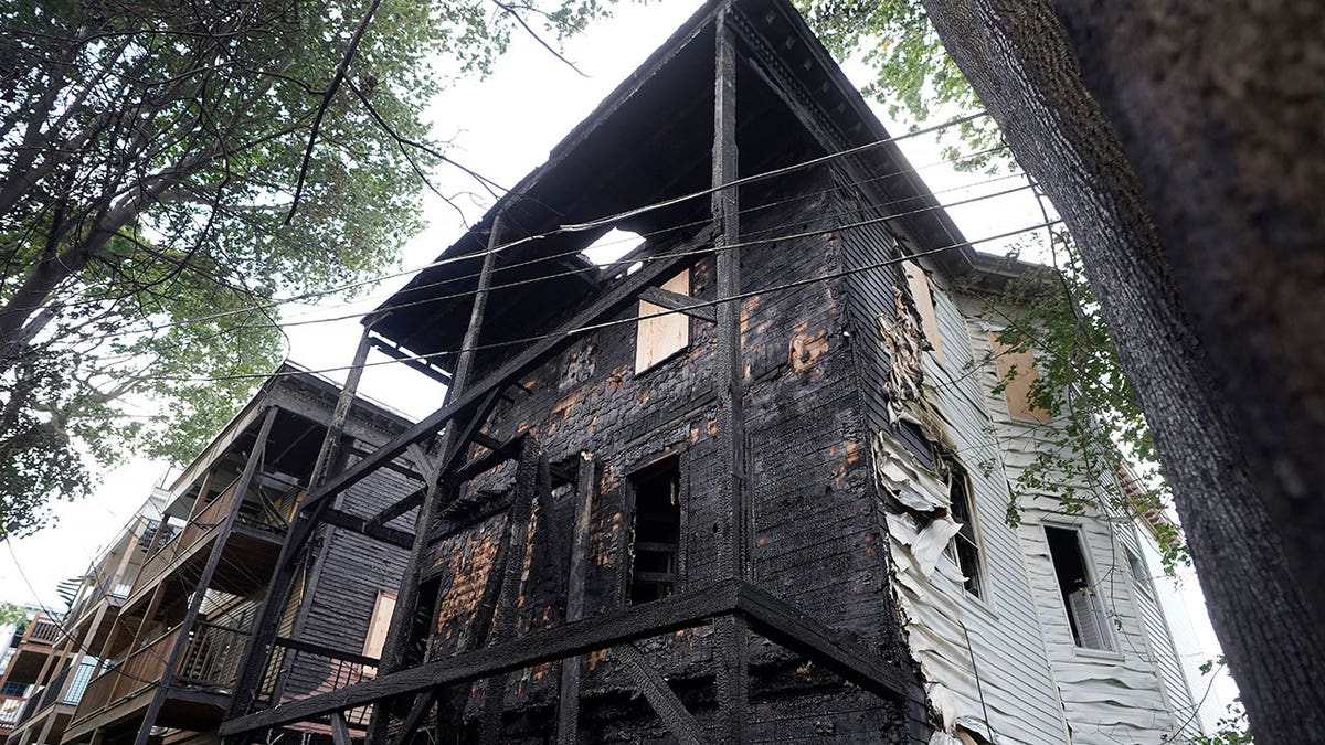 A triple-decker Boston home is seen charred and damaged after a fire