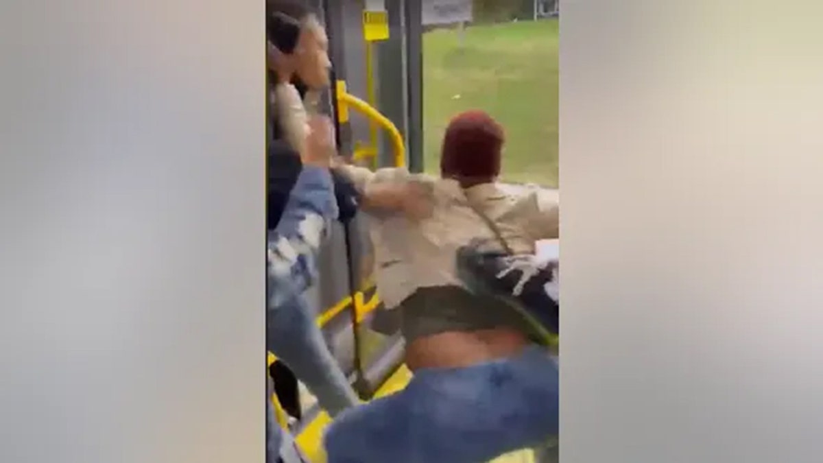 Woman being dragged off bus