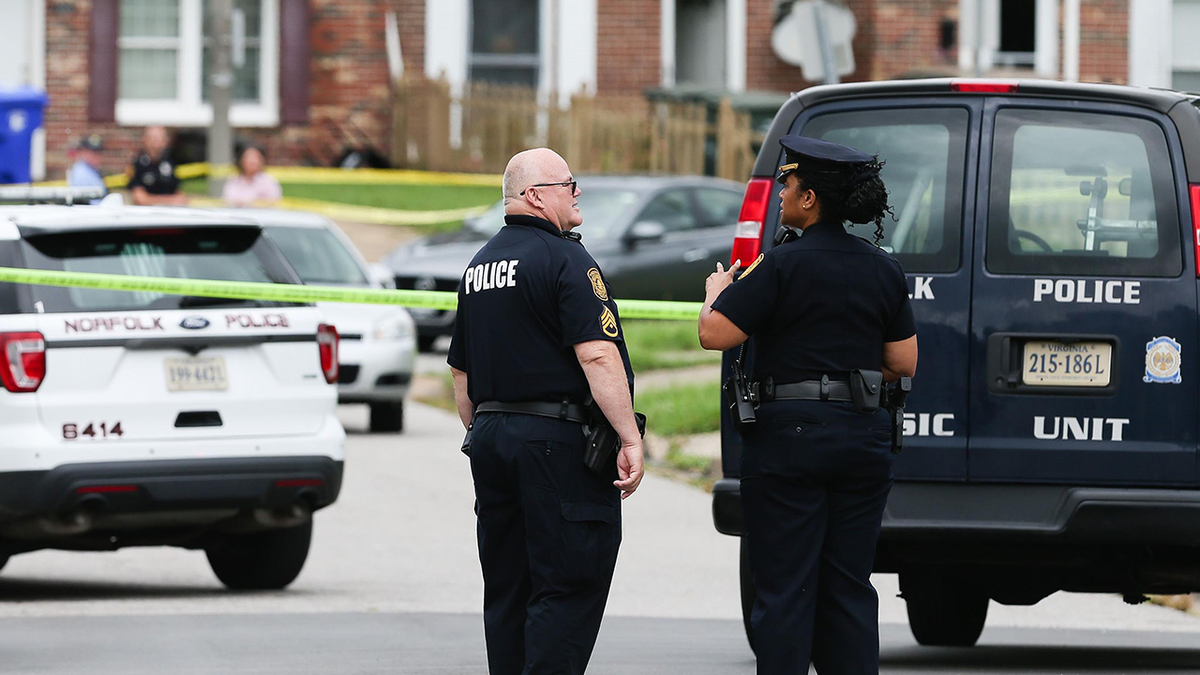 Two Norfolk Police officers outside crime scene in 2021