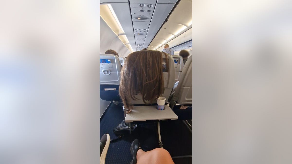 plane passenger drapes hair
