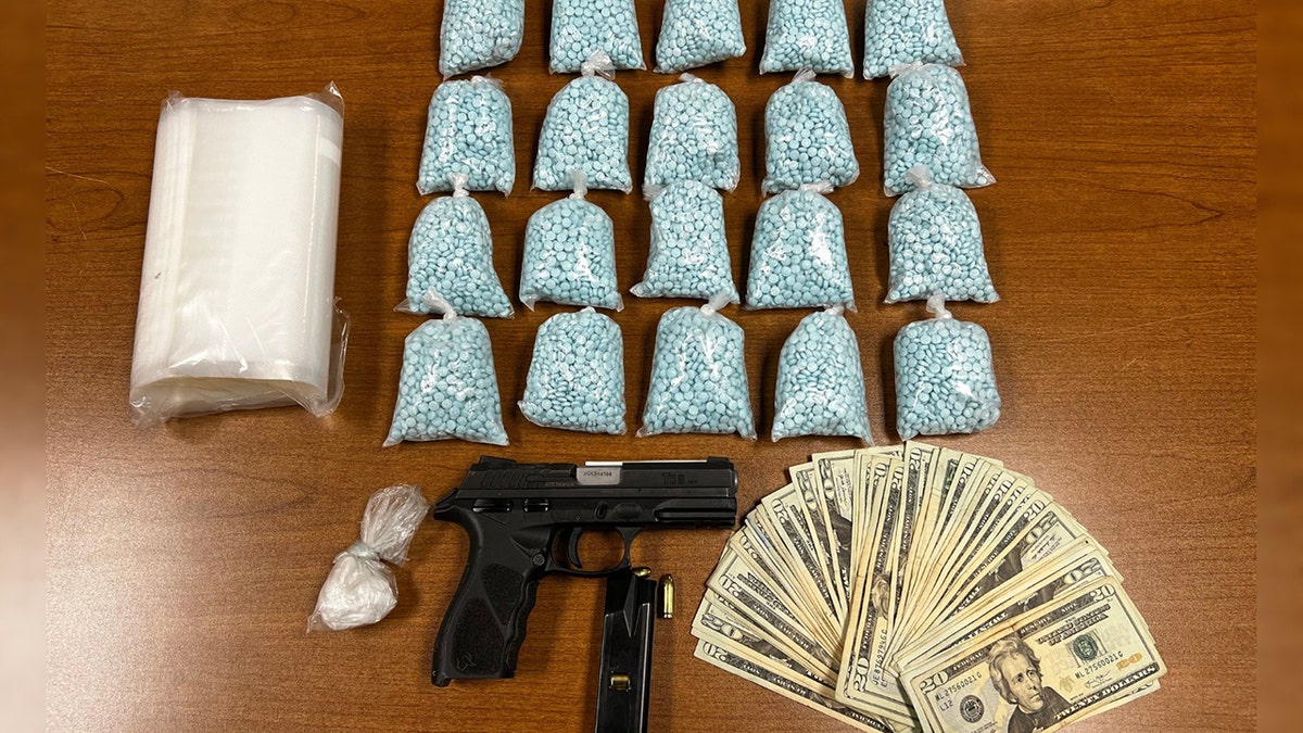 fentanyl pills, a gun, cocaine and cash