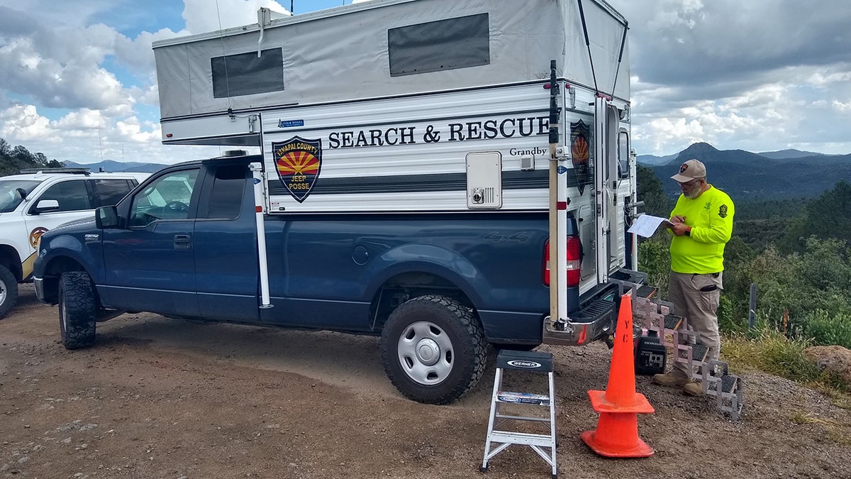 search and rescue member on trail