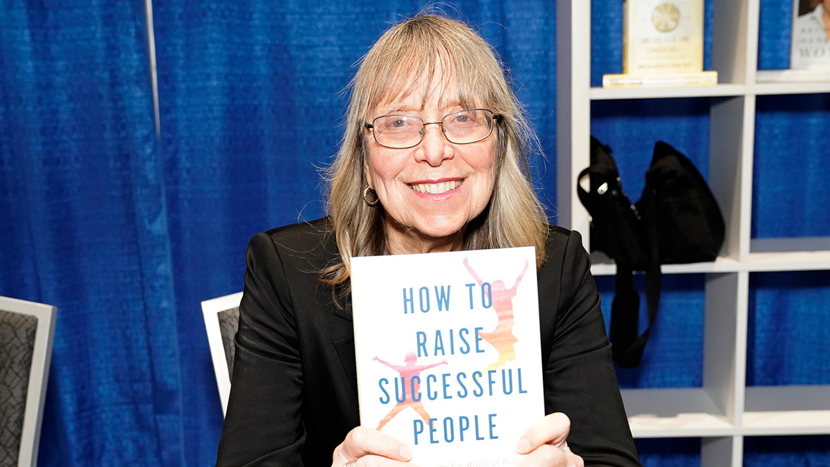 Esther Wojcicki poses with her book