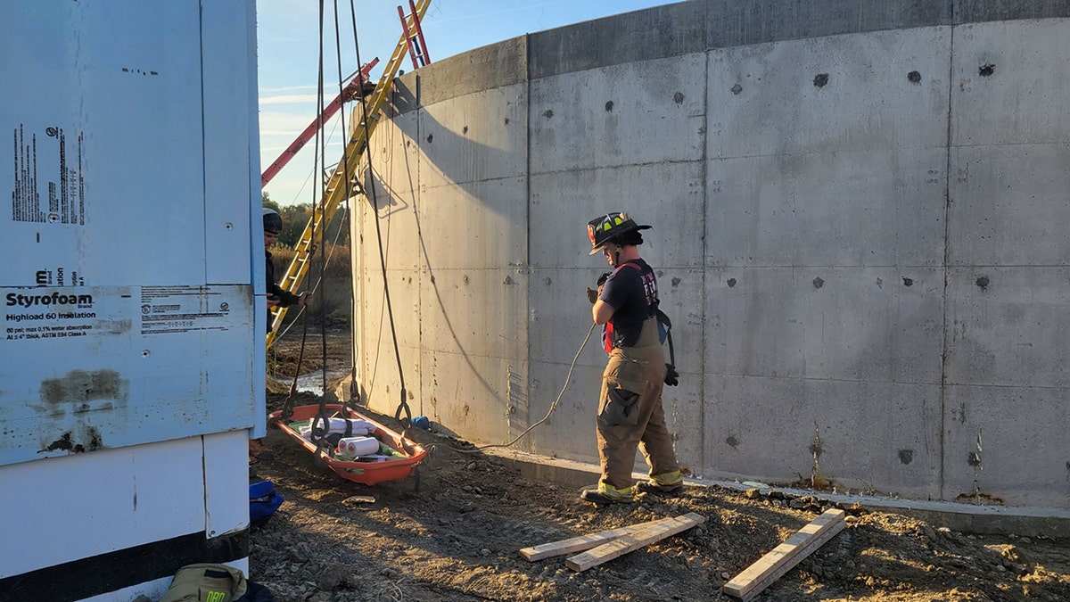 firefighter outside concrete tank