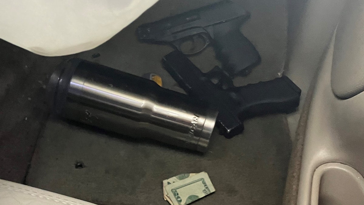 guns and cash on floor of vehicle