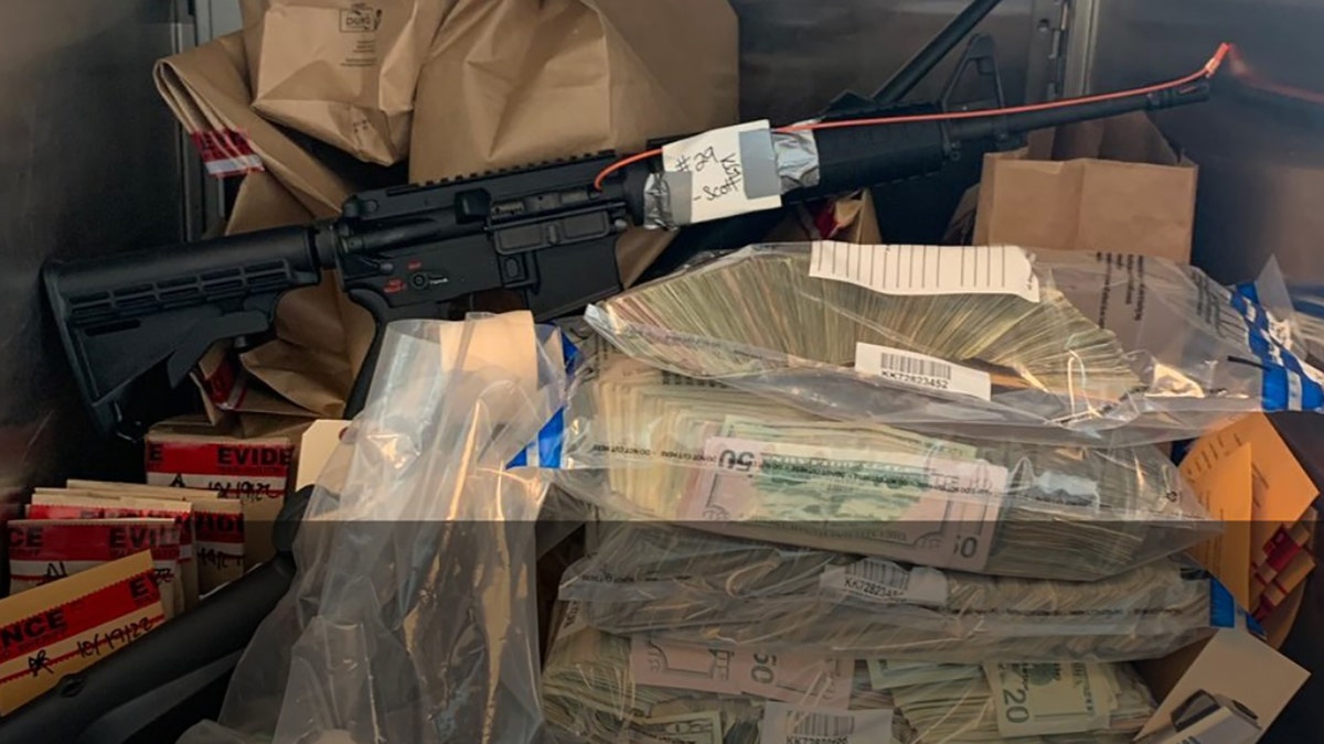 rifle and piles of cash