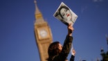 People take part in a protest against Iran's government in Parliament Square, in London, Saturday, Oct. 8, 2022.
