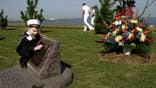 Five-year-old Eathan Costelow touches a part of the USS Cole memorial at Norfolk Naval Base October 12, 2001 in Norfolk, VA. Eathan's father, Richard D. Costelow, was one of the 17 sailors killed while onboard the USS Cole during a terrorist attack October 12, 2000 in Yemen.