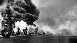 Photograph of the USS Bunker Hill taking two kamikazes. Dated 1945.