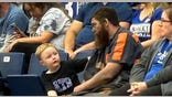 Coal miner Michael McGuire sits with son at Kentucky game