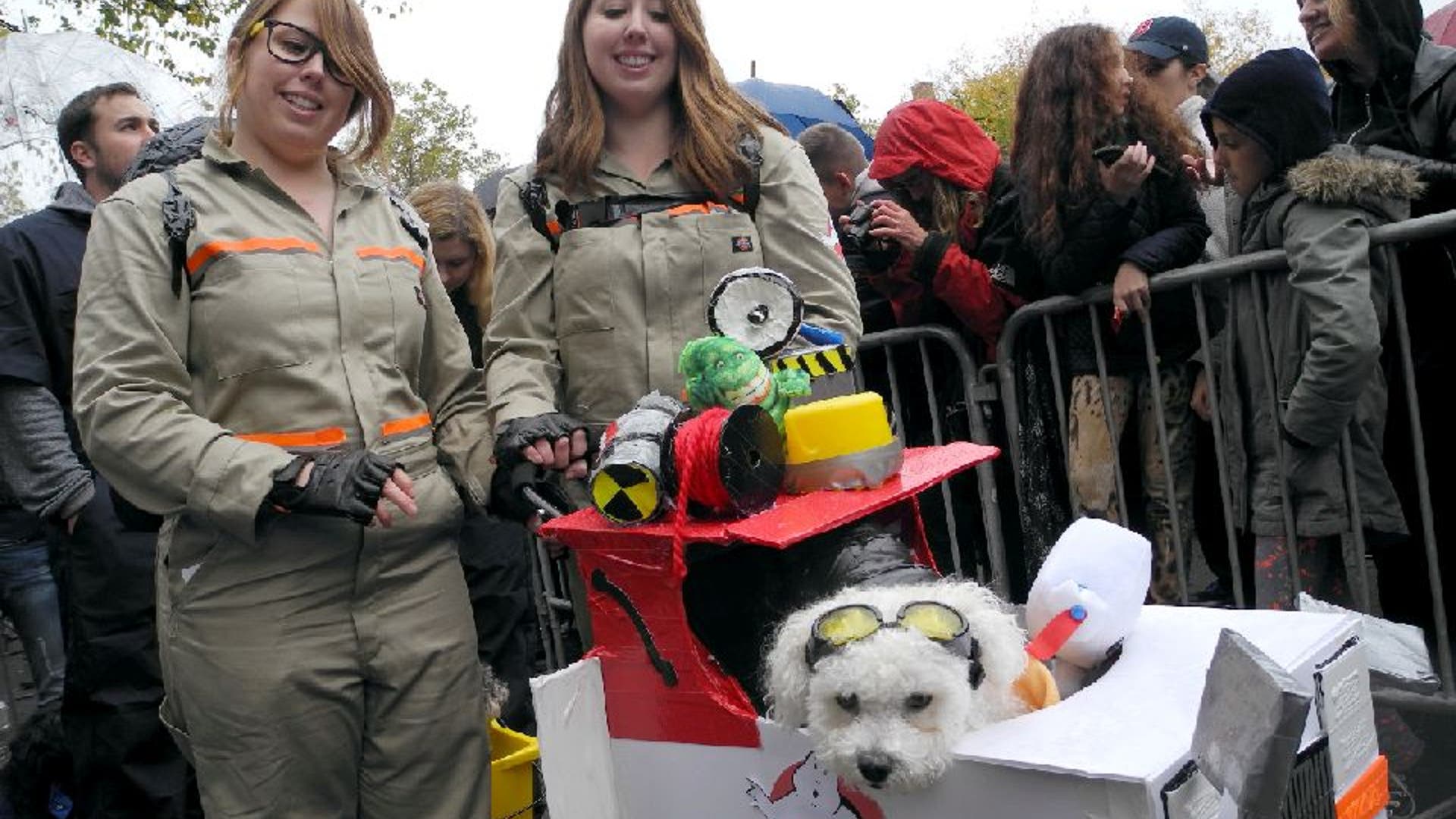 Two girls and a dog dressed in Ghostbuster costumes