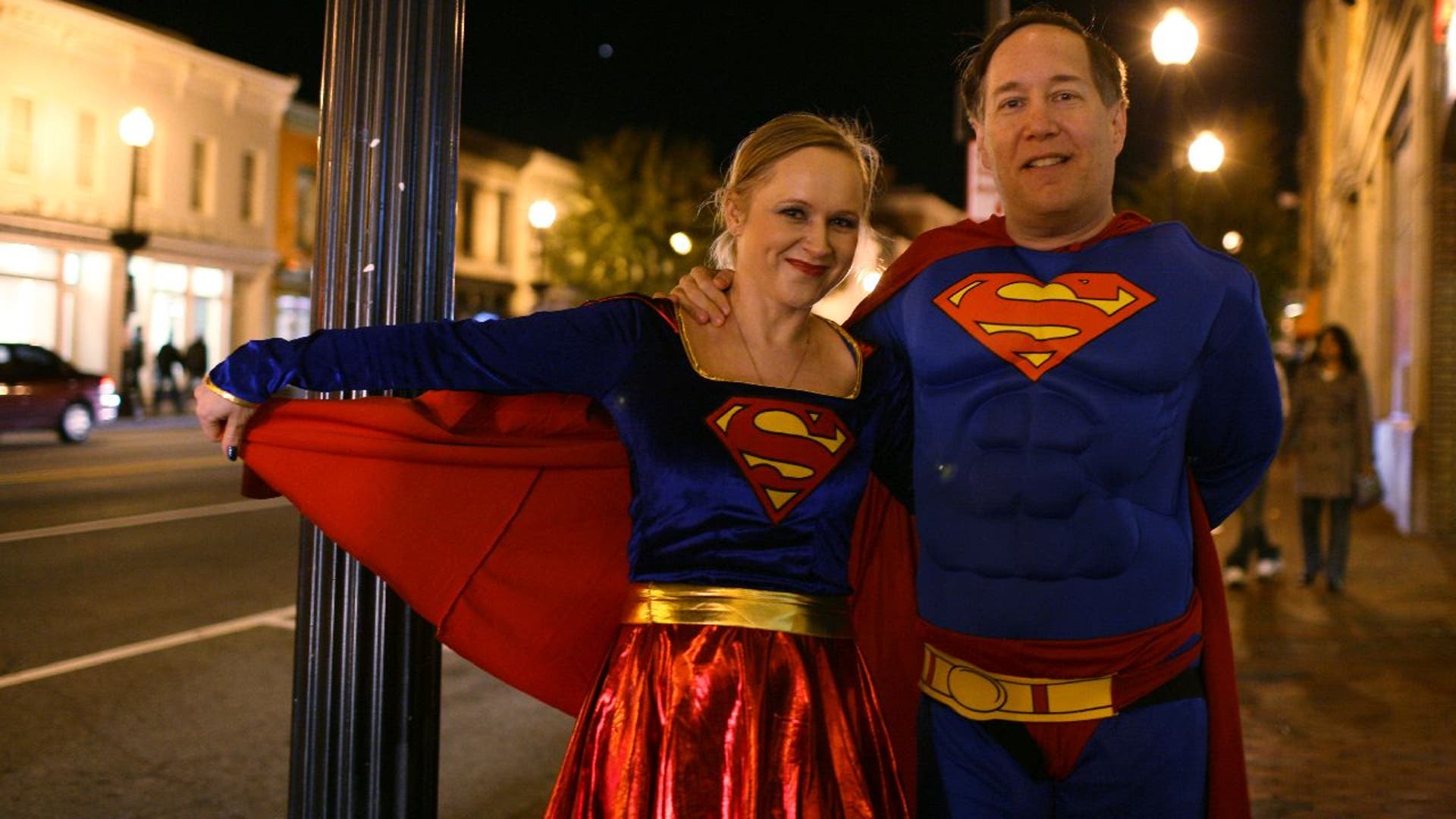 Couple dressed as Superman and Supergirl