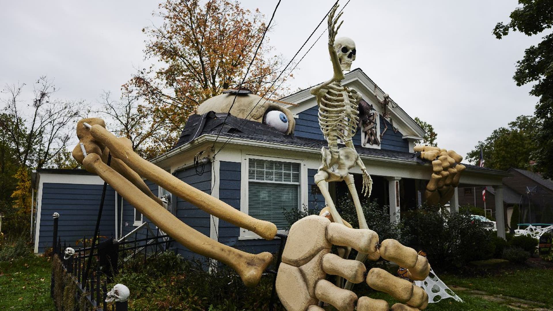 Skeleton figure in yard with giant skeletal arm