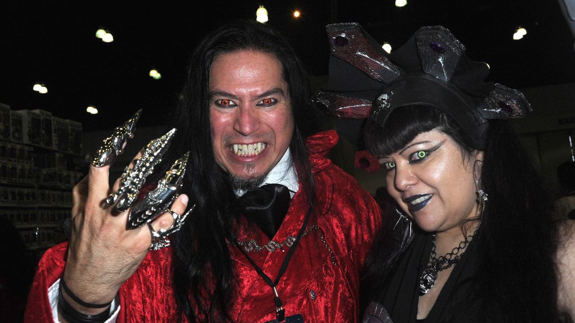 Man and woman in vampire Halloween costumes