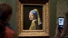 Climate activist glues his head to 'Girl with a Pearl Earring' painting in The Hague
