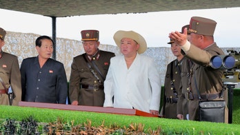 North Korea's Kim Jong Un changes up wardrobe and dons white tunic, safari hat