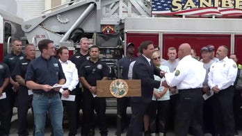 Florida Gov. Ron DeSantis hand delivers $1,000 bonus to first responders working Hurricane Ian response