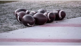 Young football player who suffered heart attack during game returns home