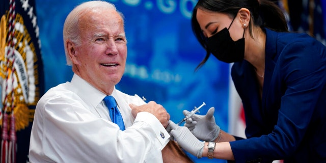 President Joe Biden receives his COVID-19 booster from a member of the White House medical unit during an event in the South Court Auditorium on the White House campus, Tuesday, Oct. 25, 2022, in Washington.