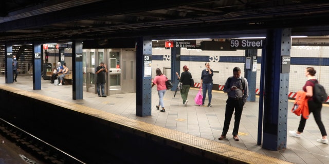 People wait for a subway train to arrive at the Columbus Circle - 59th Street station on Aug. 11, 2022, in New York City.