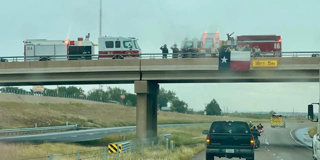 Texas firefighters salute the procession for fallen Dalhart firefighter Brendan Torres and Chief Curtis Brown.