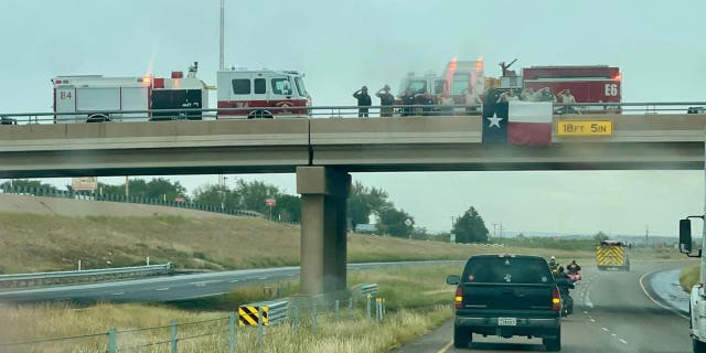 Texas firefighters salute the procession for fallen Dalhart firefighter Brendan Torres and Chief Curtis Brown.