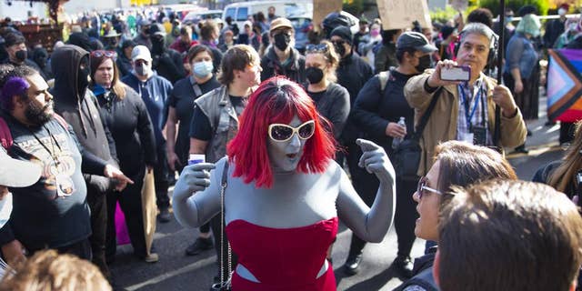 A drag performer argues with protesters at the Drag Queen Story Time event, outside Old Nick's Pub in Eugene, Oregon, October 23, 2022. 