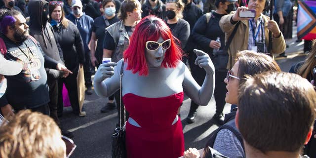 Drag performer arguing with protesters at drag queen story time event, outside Old Nick's Pub in Eugene, Oregon, October 23, 2022.
