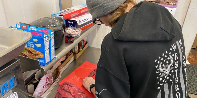 Timothy Davenport, 18, works in the store deli after he finishes his high school classes in the afternoon.