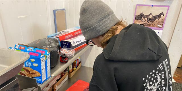 Timothy Davenport, 18, works in the store deli after he finishes his high school classes in the afternoon.