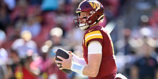 Carson Wentz of the Washington Commanders drops back to pass against the Tennessee Titans at FedEx Field on Oct. 9, 2022, in Landover, Maryland.