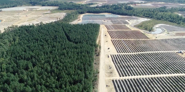 An image of a flyover shows deforestation caused by the development of a solar power project in rural Virginia.