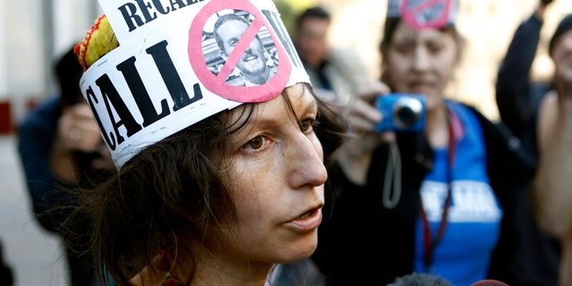 Nudist Gypsy Taub speaks with reporters after removing her clothing at the U.S. Courthouse in San Francisco, California January 17, 2013. Nudists gathered prior to a hearing on a lawsuit seeking to block implementation of San Francisco's ban on public nudity. 