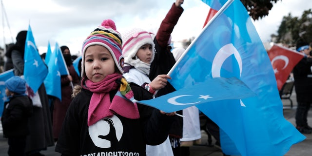 Children of China's Uyghur Muslim ethnic group take part in a Feb. 4, 2022, rally in Istanbul, Turkey, against the Beijing Winter Olympic Games over China's treatment of the minority.