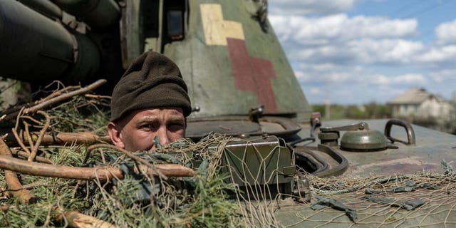 FILE PHOTO: A Ukrainian soldier looks out of a tank amid the Russian invasion of Ukraine in the frontline city of Lyman, Donetsk region, Ukraine, April 28, 2022. 