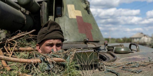 FILE PHOTO: A Ukrainian soldier looks out of a tank amid the Russian invasion of Ukraine in the frontline city of Lyman, Donetsk region, Ukraine, April 28, 2022. 