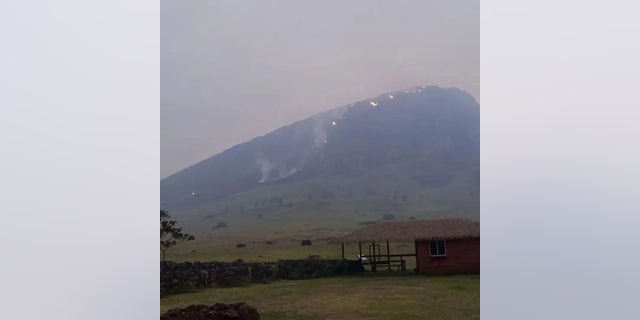 Smoke rises from a fire burning in the Rano Raraku volcanic area on Easter Island, Chile on October 6, 2022. This photo obtained from social media. 