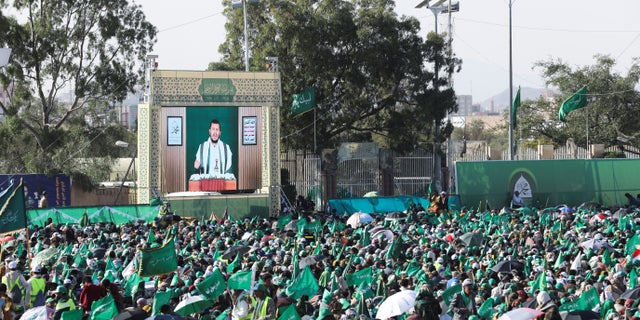 Houthi movement leader Abdul-Malik Badruddin al-Houthi addresses a demonstration to mark Prophet Muhammad's birthday via a television screen in Sanaa, Yemen, October 8, 2022. 