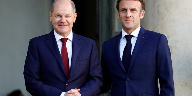 French President Emmanuel Macron welcomes German Chancellor Olaf Scholz before a meeting at the Elysee Palace in Paris Oct. 26, 2022.  