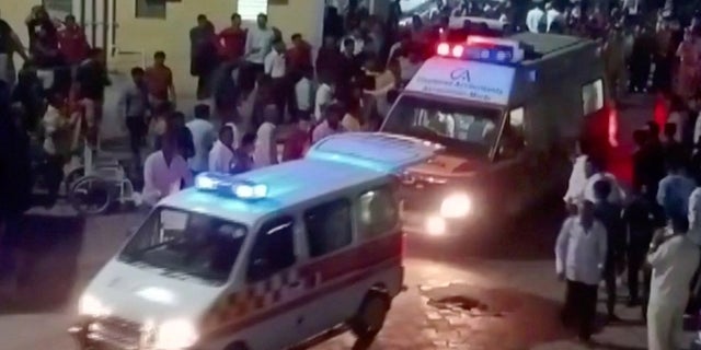 Ambulances arrive at a hospital following the collapse of a suspension bridge in Morbi, India October 30, 2022 in this screen grab obtained from a video. (ANI/ Handout via REUTERS)