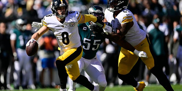 Pittsburgh Steelers quarterback Kenny Pickett evades a tackle by Eagles defensive end Brandon Graham, Sunday, Oct. 30, 2022, in Philadelphia.